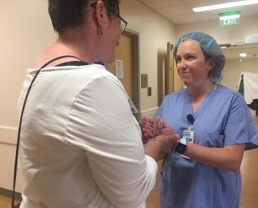 patient holding nurses hand